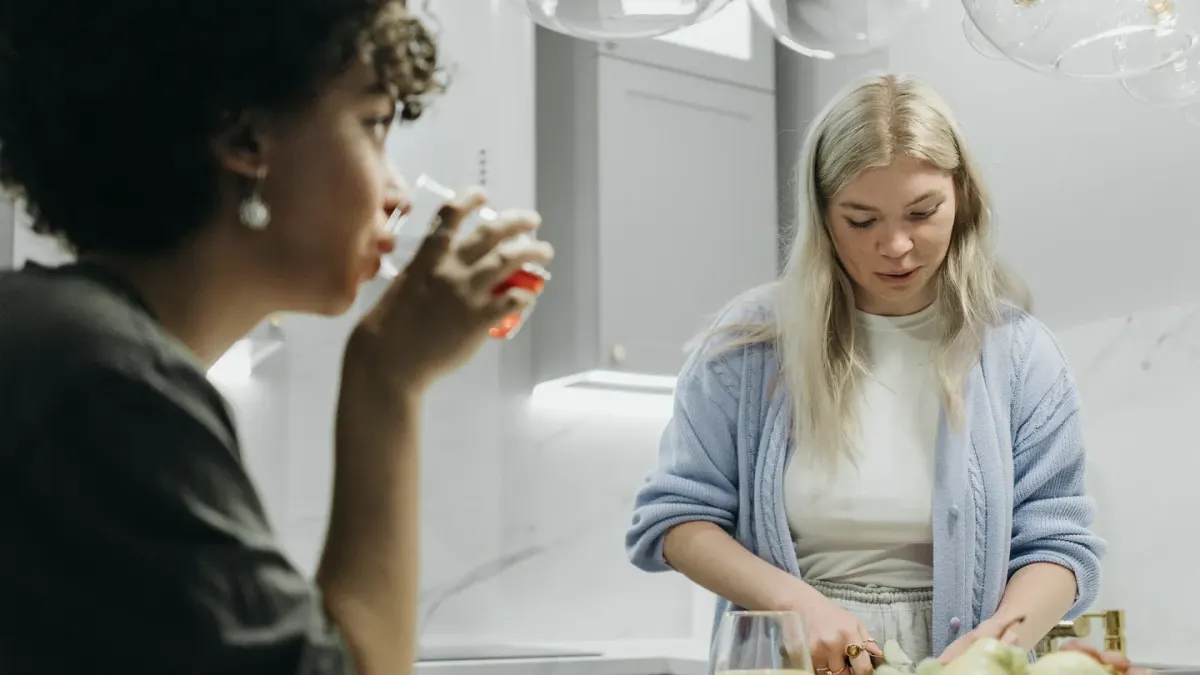 A person reading the ingredient label on a dog supplement bottle in a kitchen