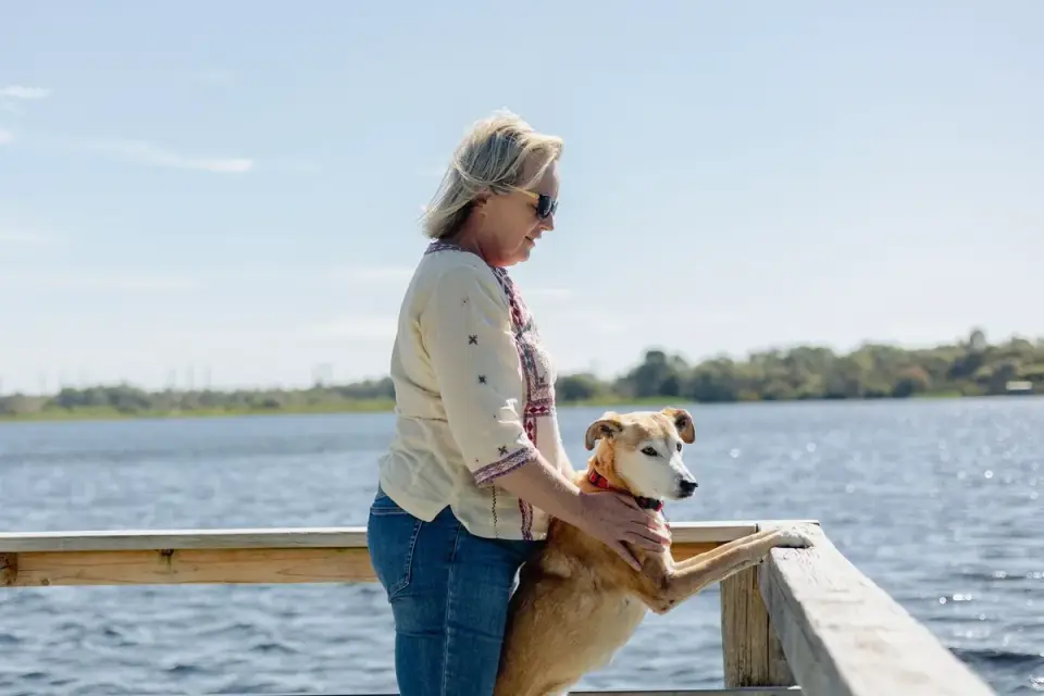 Dog owner comforting dog home