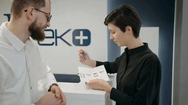 Veterinarian comparing two dog supplement labels at a clinic counter